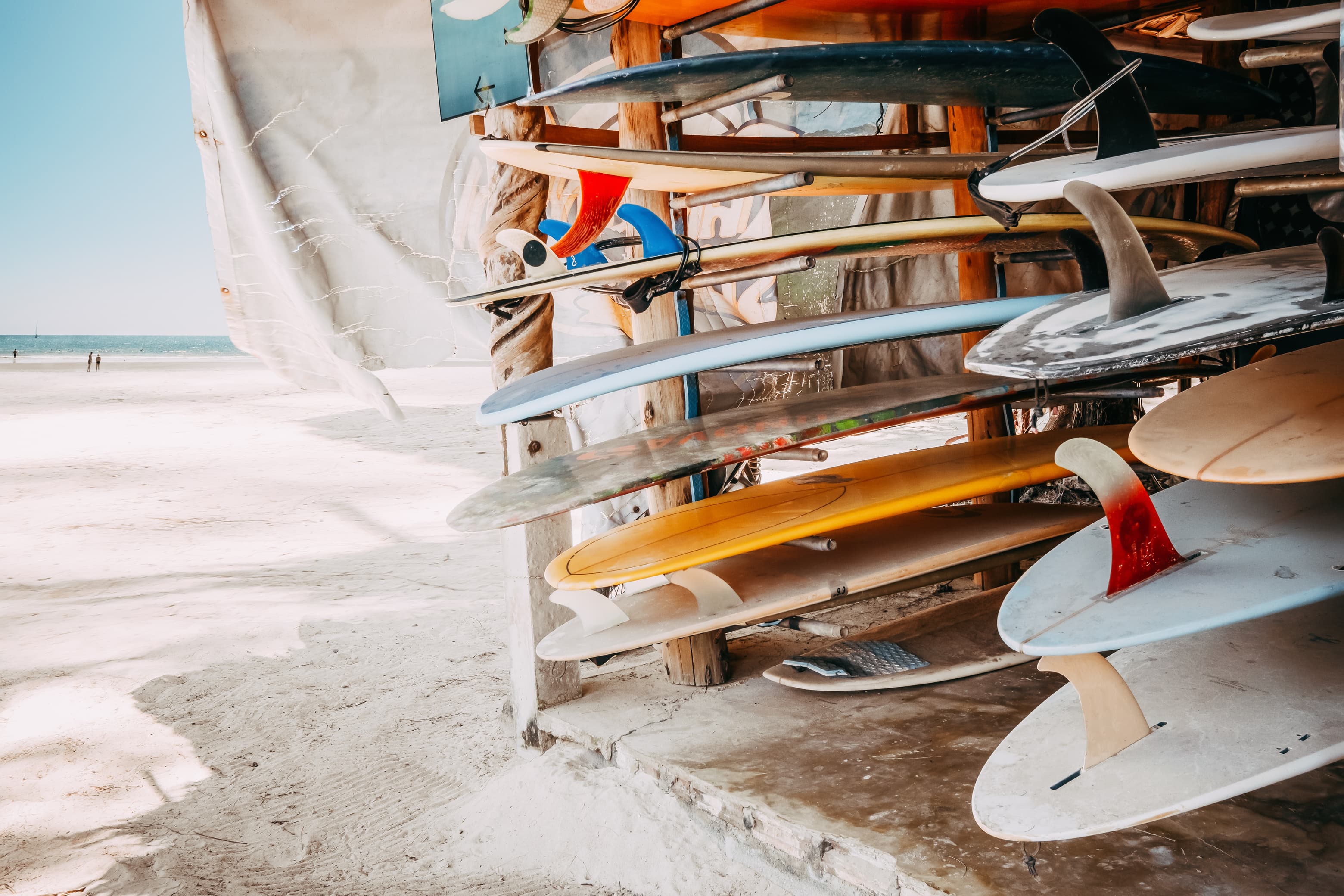 Surfboards lined up against a wall